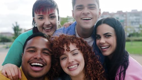 Group of people smiling at camera at city park, POV Happy friends having fun taking selfie picture o