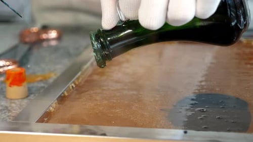 A Pastry Chef Pours Dye on Liquid Caramel in a Pastry Shop to Create a Color