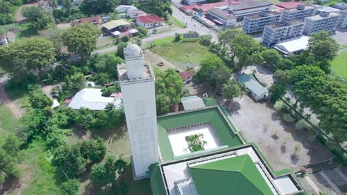 Aerial Eid Hajj Mosque tower lock track back right 360 tilt down shot