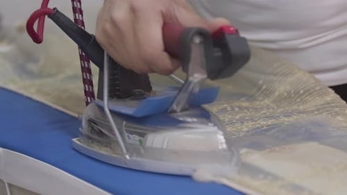 Tailor Ironing The Net Curtain
