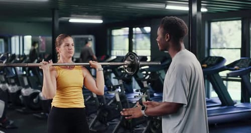 Barbell, personal trainer and training with woman in gym for weightlifting