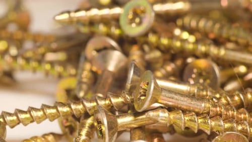 Pile of Golden Screws Close Up