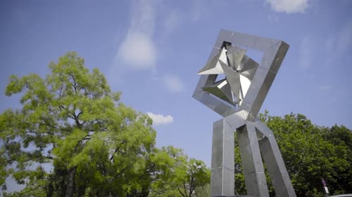Limbs of modern sculpture moving in the wind (Berlin, germany)
