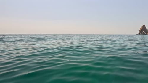 Sea Water Surface Background Low Angle View From Kayak Camera Flies Over the Clear Green Sea Water
