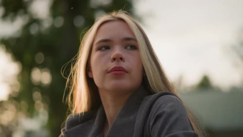 Lady in Thought with Sunlight Creating Ambient Warmth