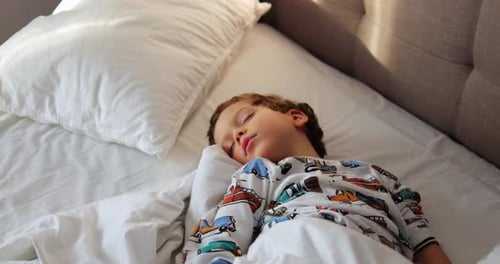 Child Sleeping Soundly in Bed in Daytime