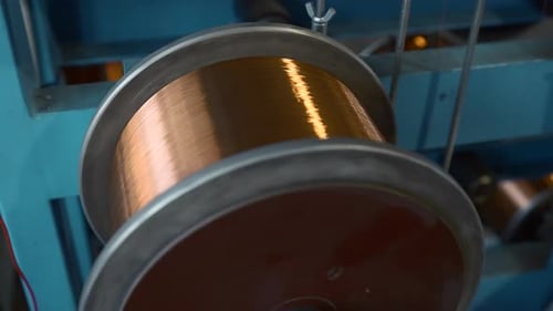 Close up of copper wires wound on huge coil. Creative.