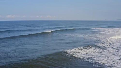 Amazing wave breaking off empty surfing beach, ocean sea aerial view