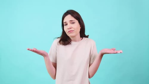 Woman Shrugging Shoulders Expressing Doubt and Confusion