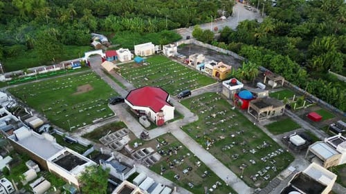 A quaint, small Catholic graveyard in a tropical island village in the Philippines with visitors dur