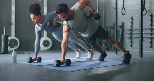 Fitness, gym and couple plank with weight dumbbell for workout, strength and training lifestyle