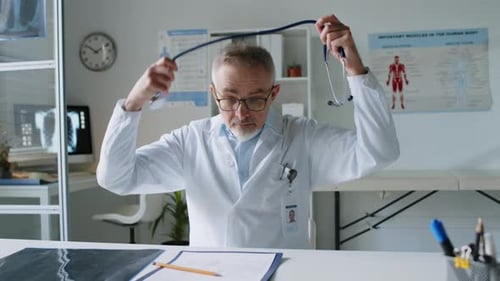 Doctor Putting on Stethoscope in Office Setting