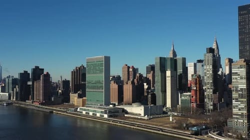distant aerial trucking shot of the United Nations building and midtown Manhattan. Chrysler and Empi