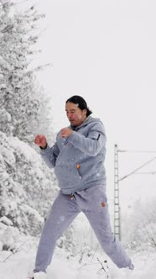 Man Training Boxing Jab Routine In Snow Street Fighter Style Drill With Guarded Stance Grey