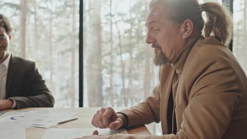 Corporate Colleagues Brainstorm at Table near Window