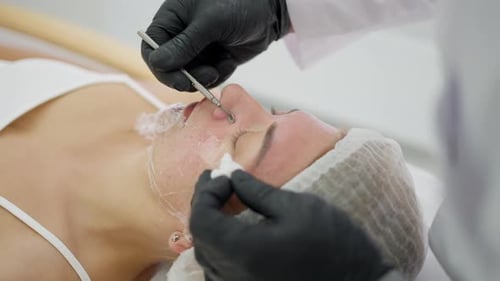 A Cosmetologist Cleans Clogged Pores on the Face