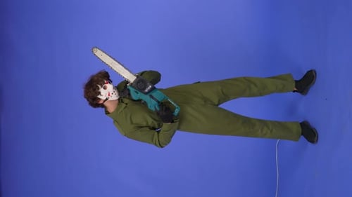 Man in White Mask with Chainsaw in Hands on Blue Background Image of Maniac Jason Voorhees From