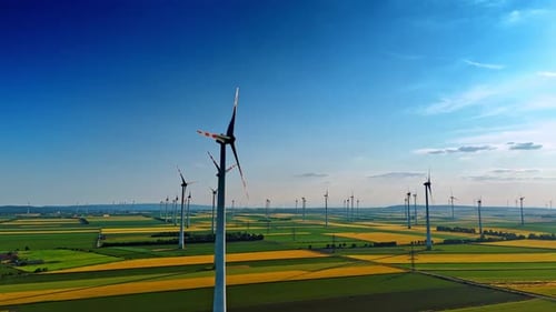 Aerial View of Wind Turbines Rotating Over Farmland