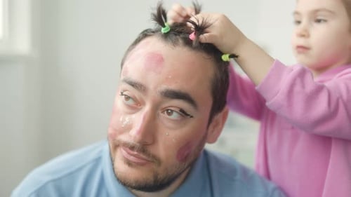 Man Getting Hair Done by Child With Makeup