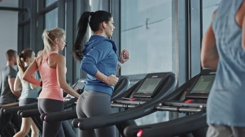 Beautiful Athletic Sports Woman Wearing Wireless Headphones, Listens to a Podcast or Sport Music Pl