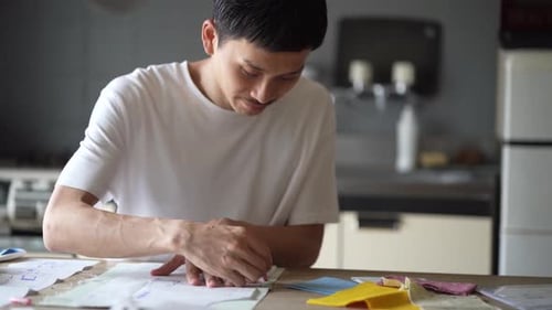 Young Adult Tracing Pattern onto Fabric Indoors
