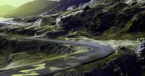 Winding Road Through Rugged Mountainscape Bathed in Golden Sunlight