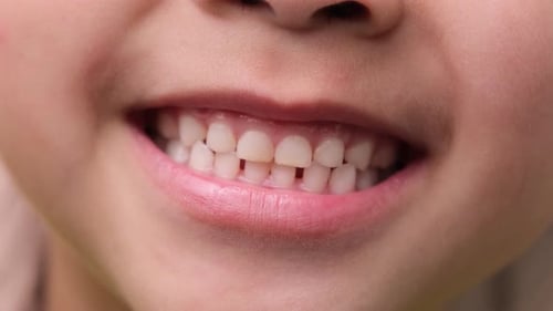 Cute little girl smile close. Close-up of young beautiful smiling girl showing her teeth isolated