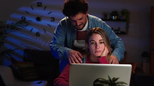 Loving Man Massaging Woman Working at Laptop