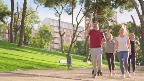 Group of Active Seniors Running Together in a Park