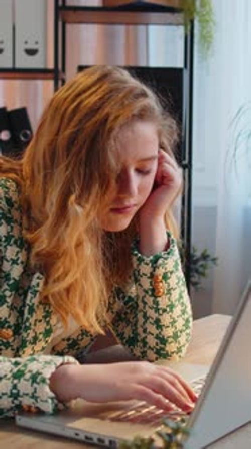 Bored Sleepy Business Woman Worker Working on Laptop Computer Yawns Leaning on Hand at Office Desk