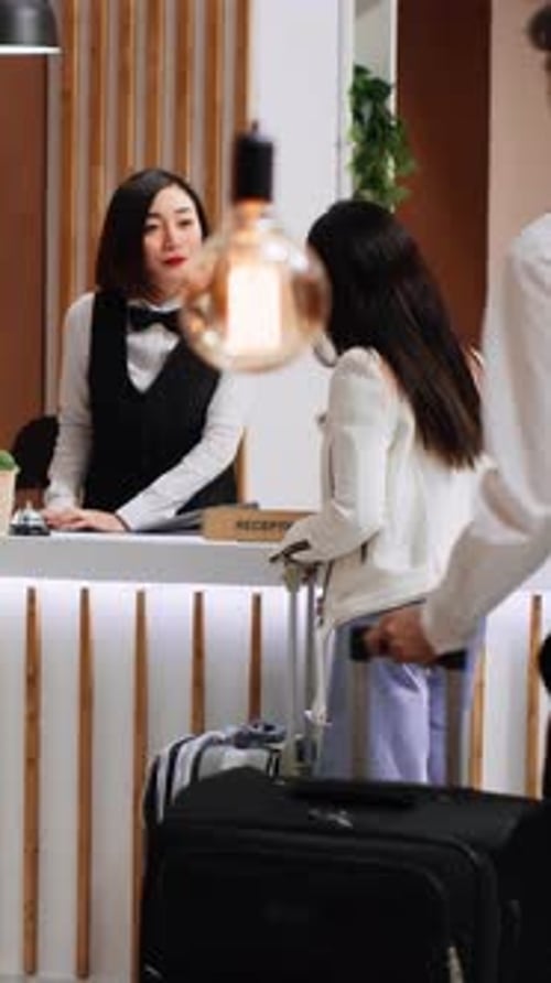 Vertical Video Young Traveler Arriving at Hotel Lobby with Luggage