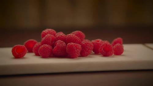 Fresh Red Raspberries on a Cutting Board