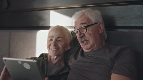 Senior Couple Using Tablet Device Together at Home