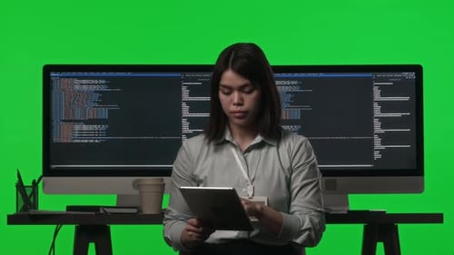 Portrait of Female Programmer with Digital Tablet in Studio with Green Wall