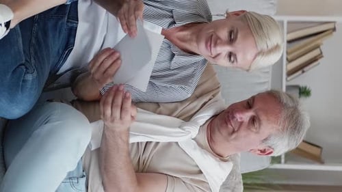 Mature Couple Looking at Photos Together on Couch