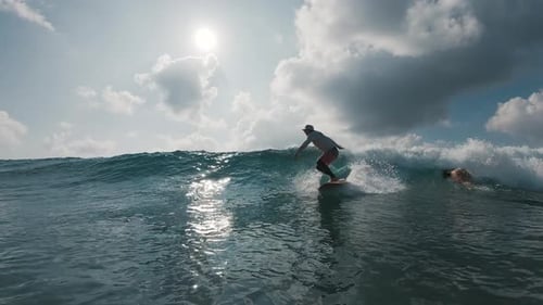 Surfer rides the ocean wave in the Maldives
