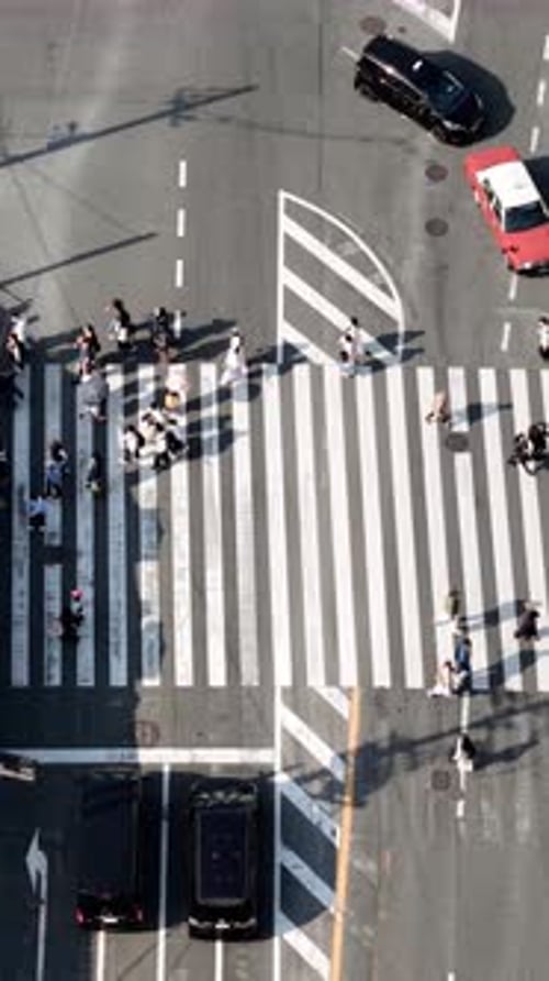 Aerial drone view of people crossing the street in Kyoto, Japan in daylight