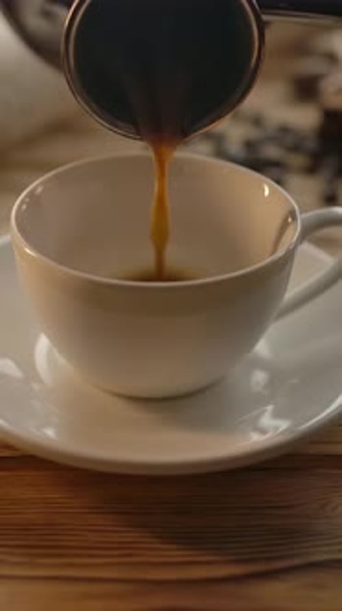 Pouring Rich Coffee in a White Mug