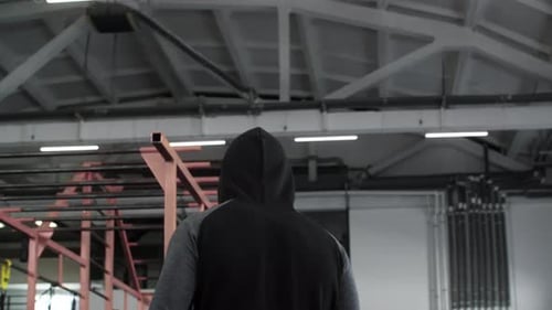Rear View of Tired Sportsman Walking in Fitness Club