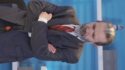Bearded Businessman Works at Computer in Office