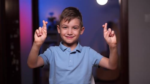 Smiling Boy with Fingers Crossed for Luck