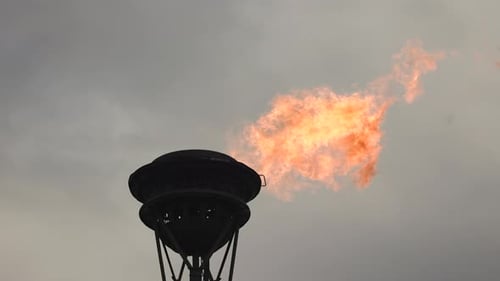 the fire burns against the sky