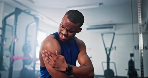 Fitness, injury and shoulder pain with black man in gym for accident, cramp or muscle fatigue
