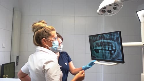 Dentist Hand Explore Study Teeth Mouth Cavity Xray on Monitor Describe Therapy to Patient at