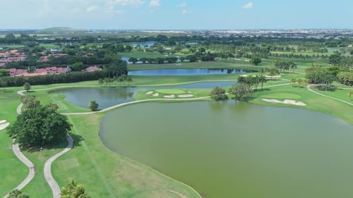 Trump National Golf Club Doral, green meadows, lakes, Florida, USA. Aerial forward