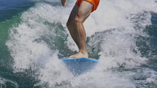 Surfer Balances on a Wave in Slow Motion