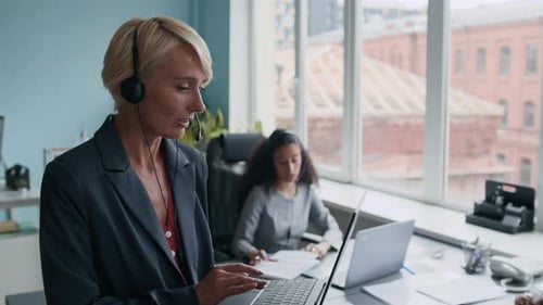 Speaking to Online Client in Headset Microphone and Looking at Laptop Screen