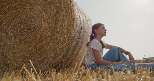 Dreamy Bliss A Girl's Serene Life in the Field Surrounded By Hay