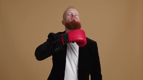 Man With Red Beard Poses with Boxing Gloves