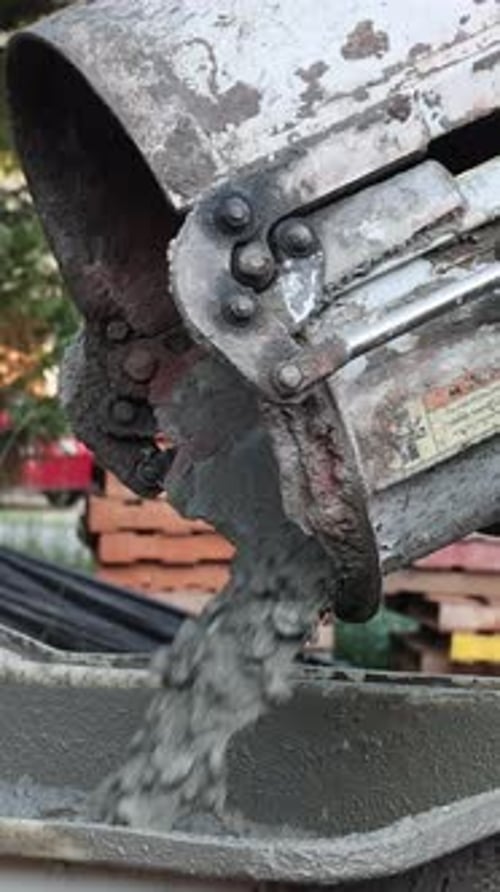Wet Cement Coming Down Cement Truck Chute Into Wheelbarrow Track Concrete Buggy
